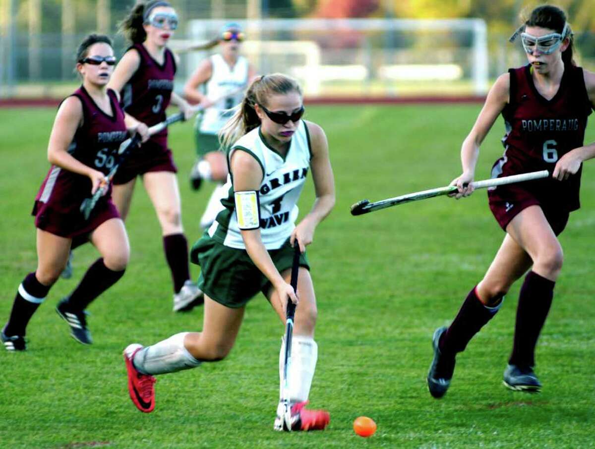 SPECTRUM/Emily Sanders of the Green Wave finds a seam in the Pomperaug defense to take the ball to the cage during New Millford High School field hockey's 1-1 deadlock with the Panthers, Oct. 7, 2011 at NMHS