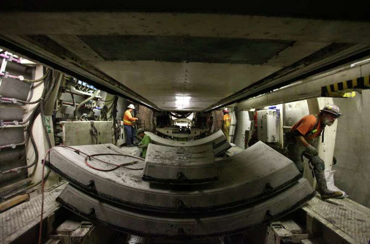 Workers place pre-cast concrete sections in the Sound Transit tunnel from the University of Washington to Capitol Hill.