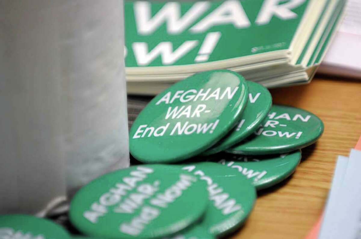 Buttons are seen on a table during a press event held by the organization Women Against War in the Legislative Office Building on Wednesday, Oct. 12, 2011 in Albany. The press event was held to announce the locations for a travel exhibit entitled "Windows and Mirrors: Reflections on the War in Afghanistan". (Paul Buckowski / Times Union)