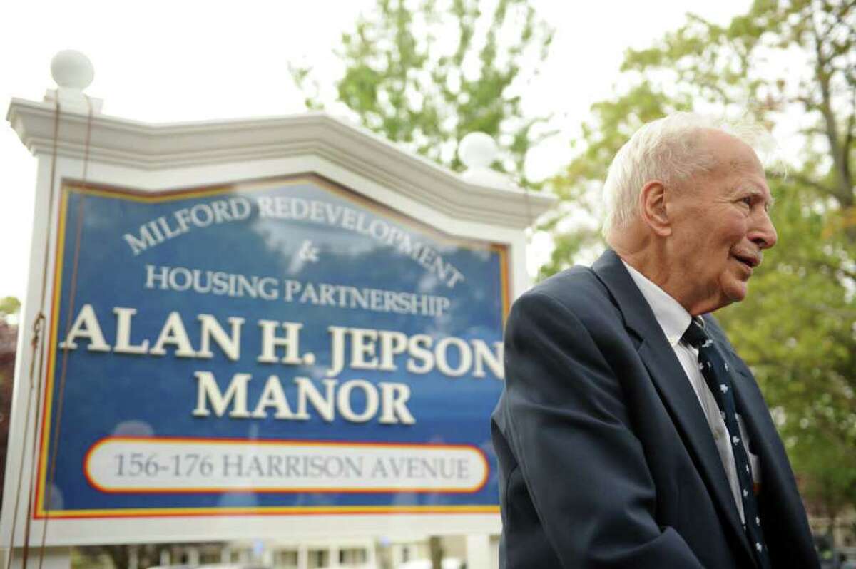 Alan H. Jepson stands in front of the sign bearing his name during a dedication ceremony Wednesday, Oct. 12, 2011 renaming the Walnut Beach public housing complex the Alan H. Jepson Manor Public Housing Development.
