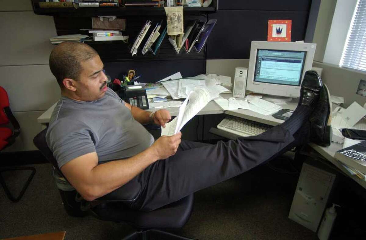 Archive: San Antonio Express-News columnist Cary Clack goes over a story in his office.