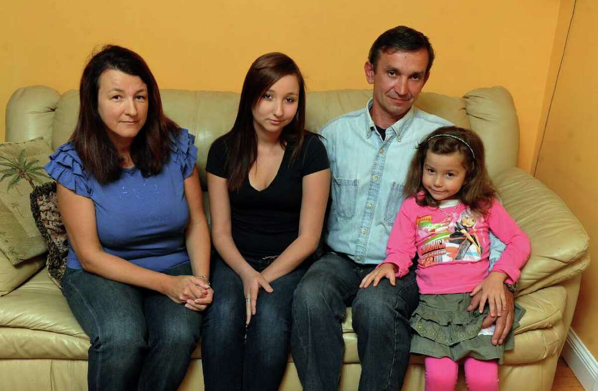 Paulina Krynska, 19, poses with her family while at her home in Monroe, Conn. on Wednesday October 12, 2011. From left to right is mom Ewa Krynska, Paulina, dad Darius Krynski, and sister Victoria Krynski, 5. Paulina came to the US with her family from Poland when she was 11 years old. She received a letter from the INS in which she was the subject of removal for violation of her immigration status.