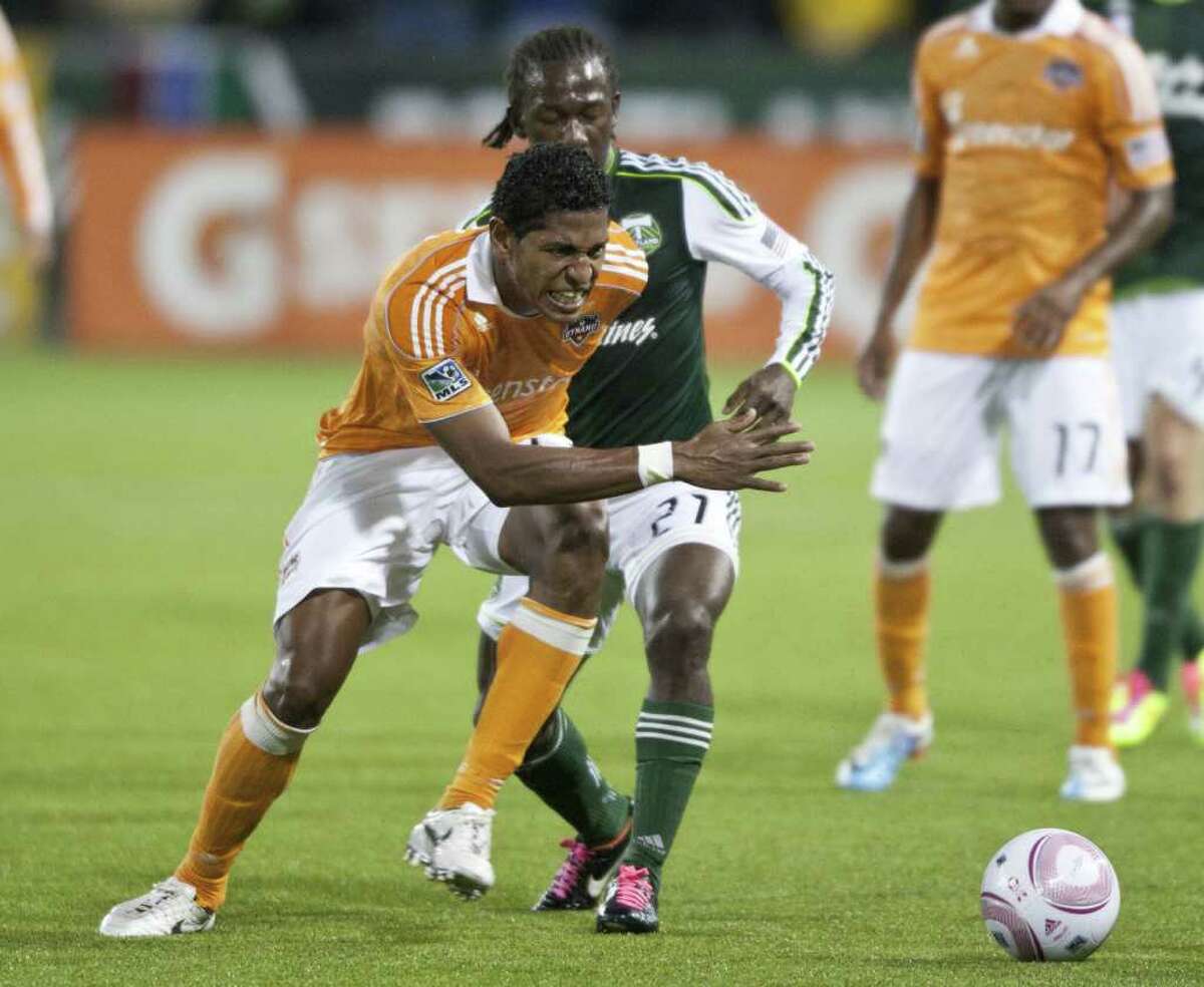 PORTLAND, OR - OCTOBER 14: Carlo Costly #29 of the Houston Dynamo plays against Diego Chara #21 of the Portland Timbers at Jeld-Wen Field on October 14, 2011 in Portland Oregon.