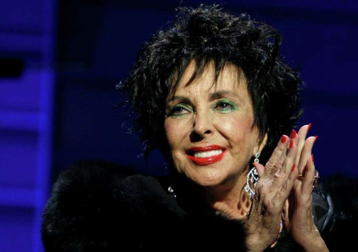 FILE - In this Sept. 25, 2008 file photo, Elizabeth Taylor speaks during the 26th Annual Macy's Passport to Fashion gala in Santa Monica, Calif. Family and friends of Taylor gathered on the Warner Bros. lot on Sunday, Oct. 16, 2011, for a private memorial service seven months after the death of the Hollywood legend to commemorate her life and career, some of which played out at the studio. (AP Photo/Matt Sayles, File)