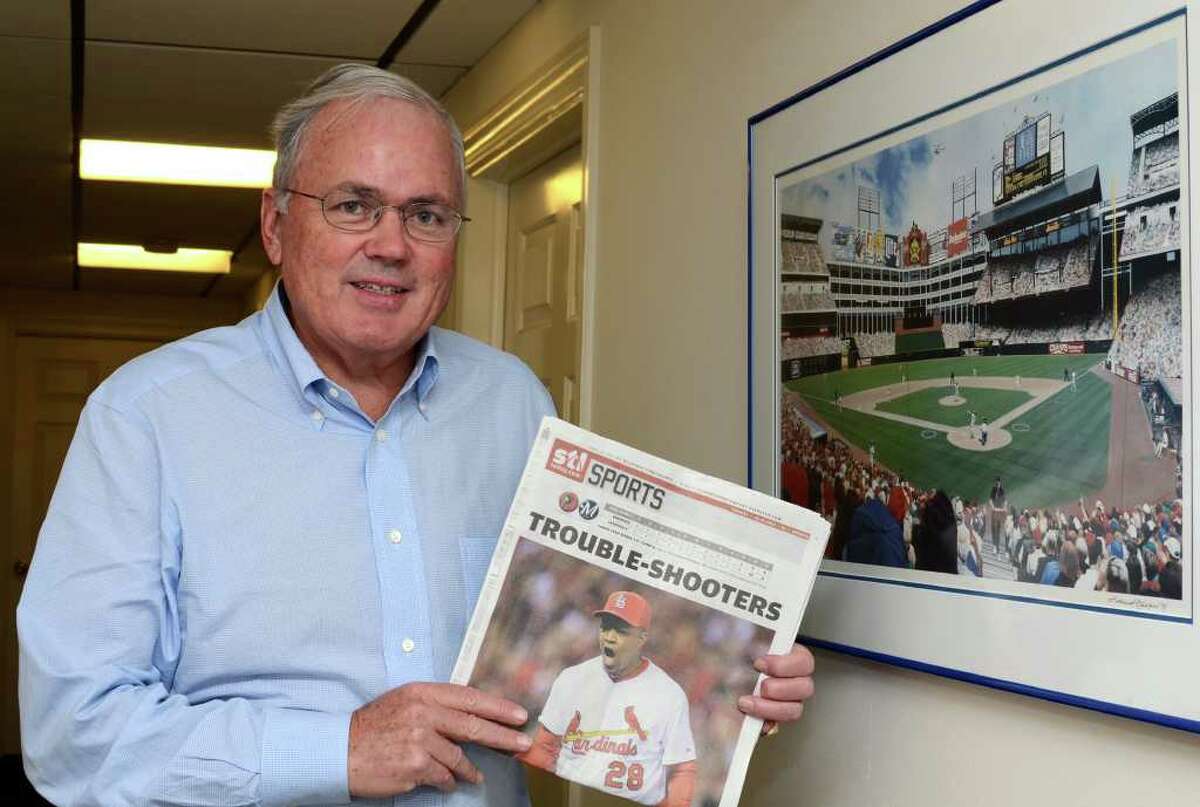 Craig Roberts Stapleton poses next to a framed photograph of Rangers Ballpark in Arlington while holding the front sports page of Sunday's STLToday newspaper featuring the Cardinals in his office at 315 East Putnam Avenue in Greenwich on Monday, Oct. 17, 2011. Stapleton co-owned the Texas Rangers baseball team with George W. Bush and in July 2009, he became a co-owner of the St. Louis Cardinals.