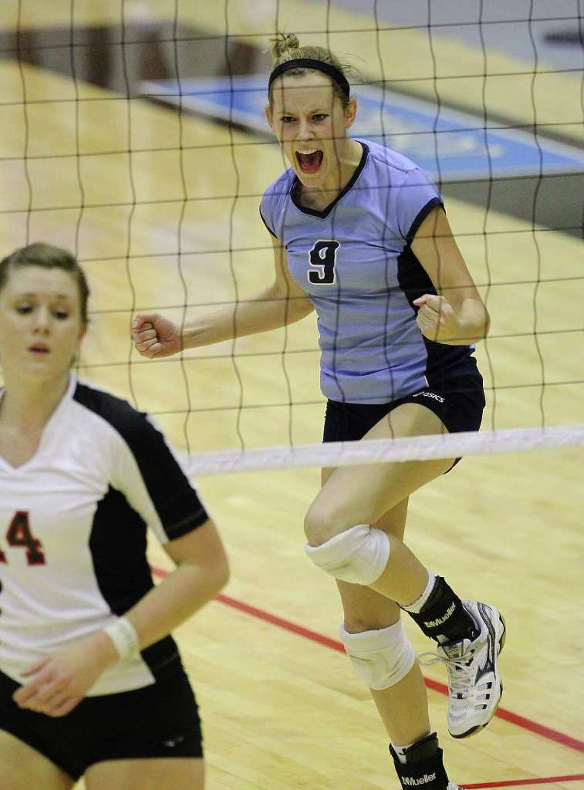 Johnson's Kassie Freitag (09) reacts after winning a point against Churchill's Audrey Sanders (14) in volleyball at Littleton Gym on Tuesday, Oct. 18, 2011. Johnson defeated Churchill in three straight games. Kin Man Hui/kmhui@express-news.net