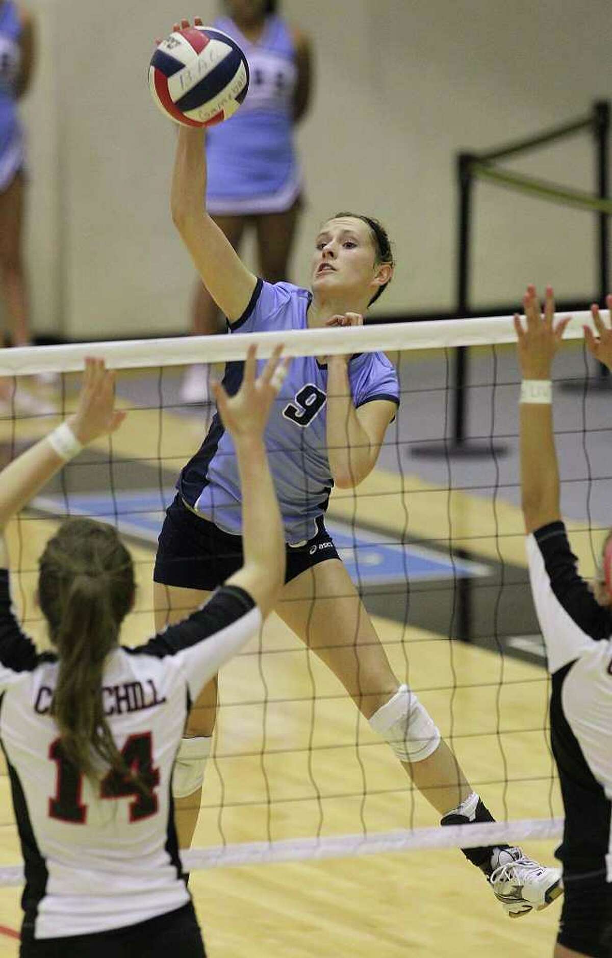 Johnson's Kassie Freitag (09) looks to score against Churchill's Audrey Sanders (14) and Jordan Holub (04) in volleyball at Littleton Gym on Tuesday, Oct. 18, 2011. Johnson defeated Churchill in three straight games. Kin Man Hui/kmhui@express-news.net