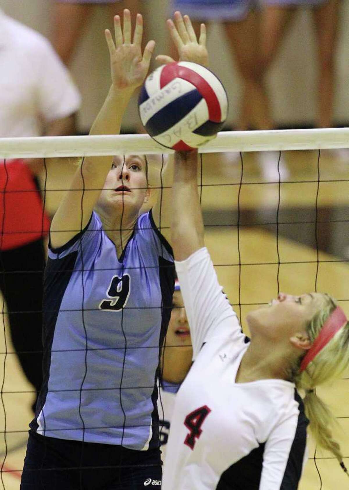 Johnson's Kassie Freitag (09) attempts to block a shot by Churchill's Jordan Holub (04) in volleyball at Littleton Gym on Tuesday, Oct. 18, 2011. Johnson defeated Churchill in three straight games. Kin Man Hui/kmhui@express-news.net