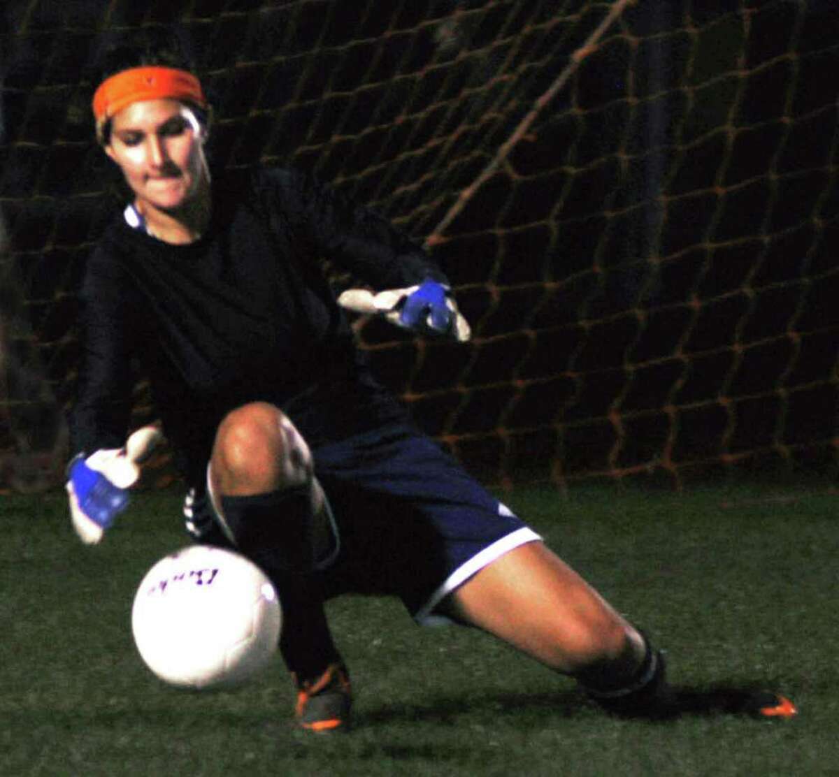 SPECTRUM/Goalkeeper Jane Thompson of New Milford High girls' soccer grabs a loose ball during NMHS' 1-1 draw with visiting Newtown, Oct. 13, 2011