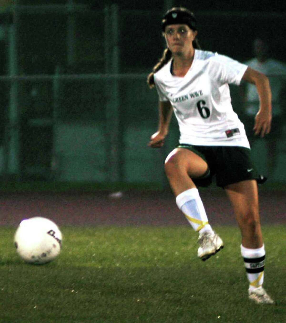SPECTRUM/Michaela Edmond of the New Milford High girls' soccer side redirects the ball upfield to a Green Wave teammate during NMHS' 1-1 draw with visiting Newtown, Oct. 13, 2011