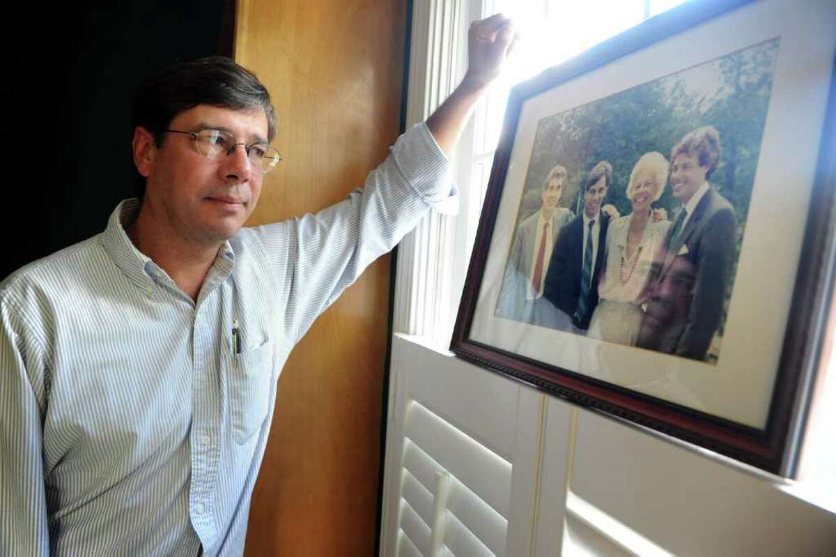 Paul Zwynenburg, at his home in Fairfield, Conn. Thursday, Oct. 20, 2011, looks at the last photo taken with his family intact. His brother, Mark Zwynenburg, far right, was killed in 1988 when his Pan Am flight 103 was blown up over Lockerbie, Scotland.