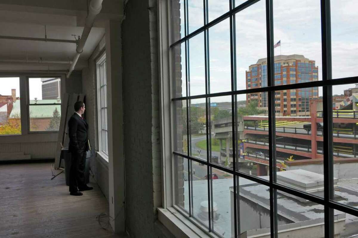 Dan Kelleher, Business Development Manager of the Downtown Albany Business Improvement District, looks out the window of a building being converted into apartments at 4-6 Sheridan Avenue, on Tuesday Oct. 18, 2011 in Albany, NY. (Philip Kamrass / Times Union )