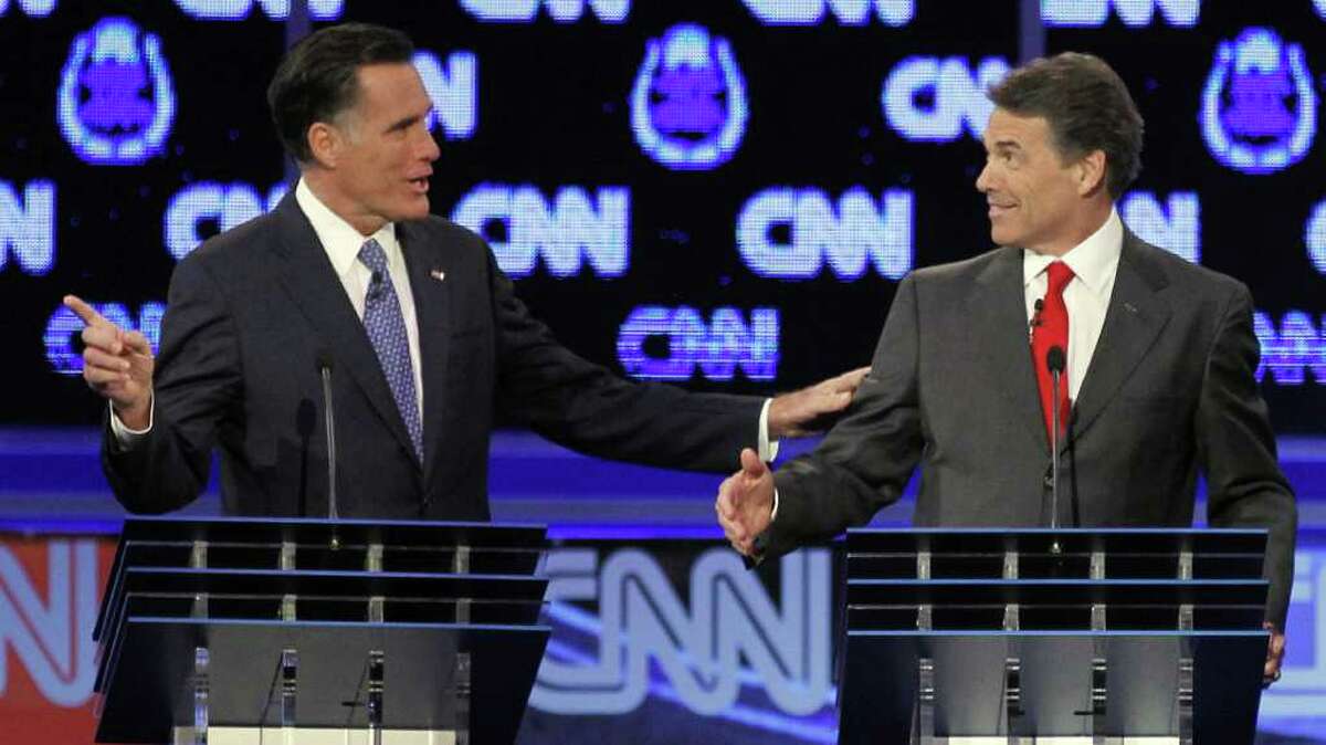 Two Republican presidential hopefuls in Las Vegas: At one point ex-Massachusetts Gov. Mitt Romney (left) was ruffled by Texas Gov. Rick Perry, but in the end, the former remained the man to beat.