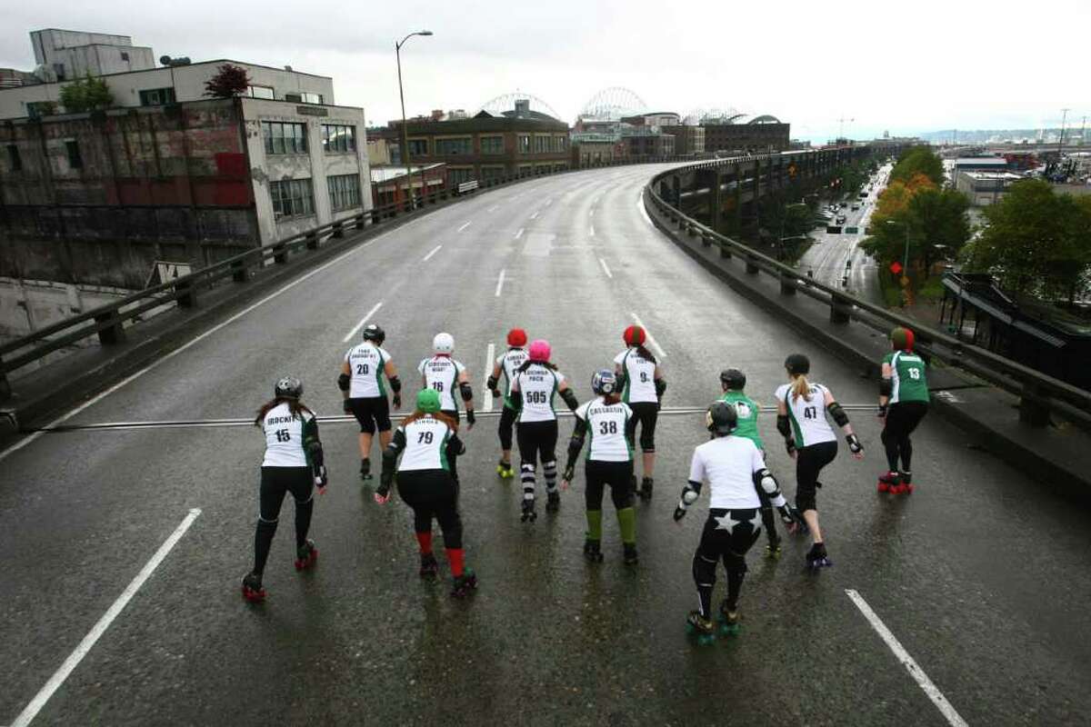 Members of the Rat City Rollergirls flat-track roller derby league skate on the upper deck of the closed Alaskan Way Viaduct on Saturday, October 22, 2011 in downtown Seattle. They were winners of a contest where organizations made pitches about what they would do on the deck of the closed highway for half an hour. The highway usually carries 110,000 cars per day and will be closed for nine days as demolition of the southern half of the aging structure begins. The highway, built in the 1950s, will be replaced with a new deep bore tunnel along the Seattle waterfront.