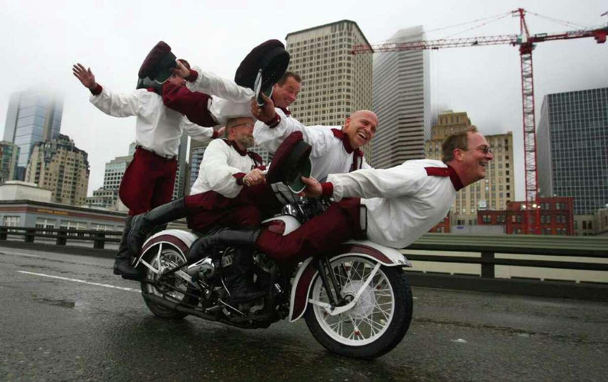 Members of the Seattle Cossacks classic motorcycle stunt team perform on the upper deck of the closed Alaskan Way Viaduct in downtown Seattle. They were winners of a contest where organizations made pitches about what they would do on the deck of the closed highway for half an hour. The Cossacks performed their signature tricks on the highway.