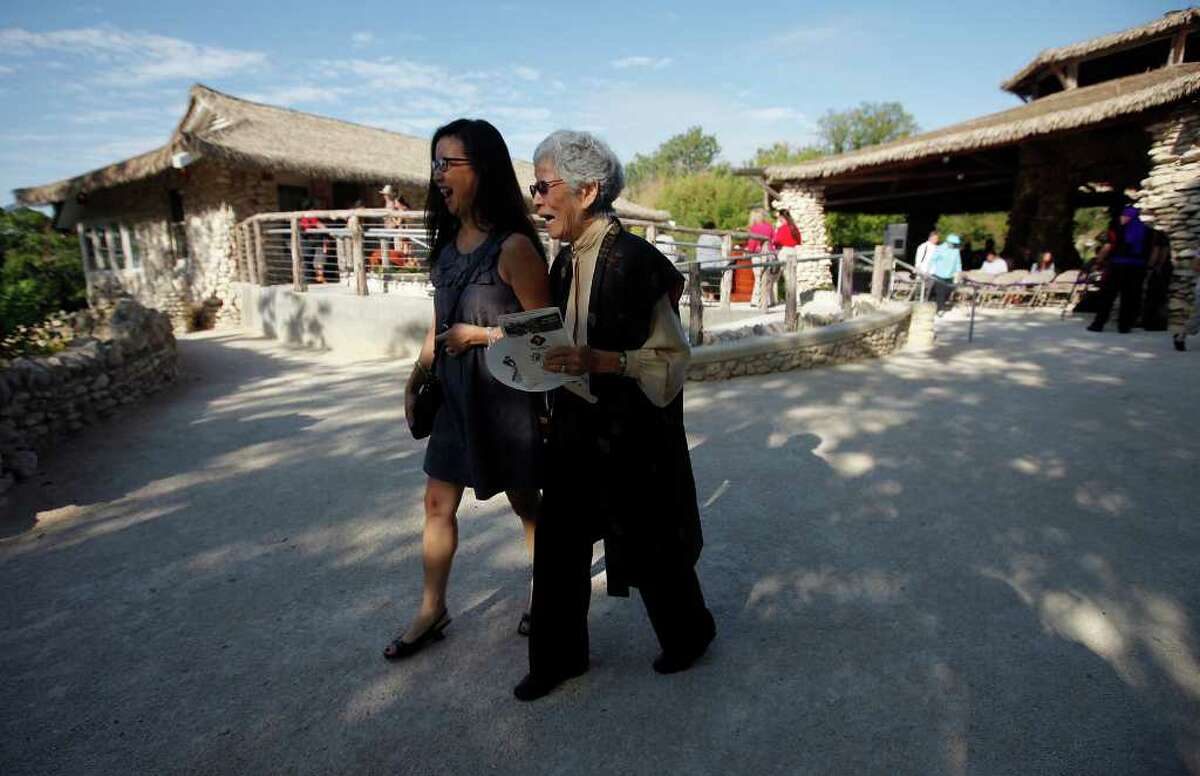 Mabel Jingu Enkoji, 86, laughs as she walks with her daughter, Peggy Nishio, on the grounds of the Japanese Tea Garden on Saturday, Oct. 22, 2011. They attended the grand re-opening ceremony of the Japanese Tea Garden after a $1.2 million renovation by the city. Guests of honor included members of the Jingu family such as Enkoji who once lived in the house. The house has been fully renovated and will be open for public use as well as offer food and drink services for visitors to the garden located near downtown.