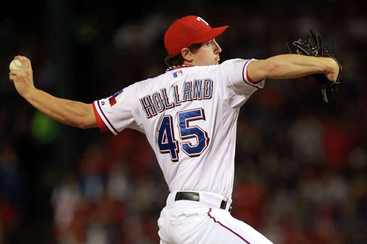 Texas Rangers starting pitcher Derek Holland (45) delivers to the