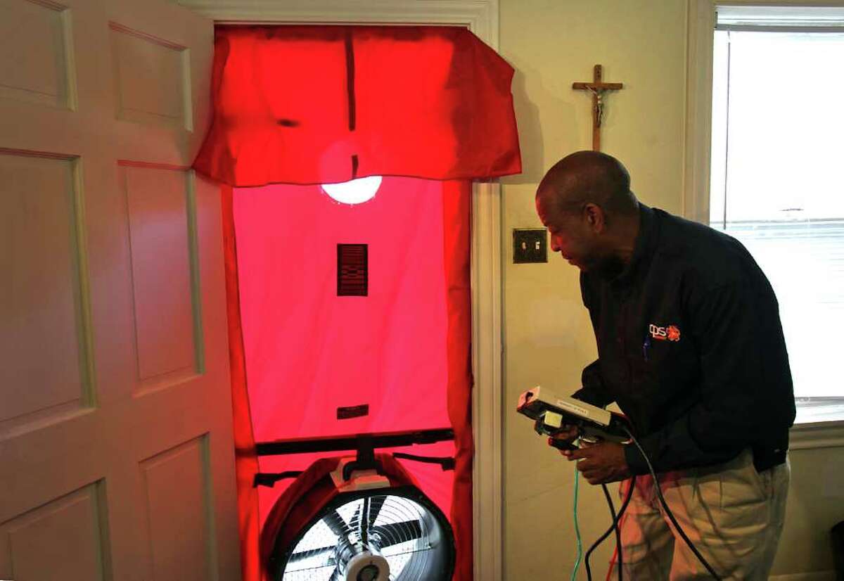 Kirk Nuckols, Field Representative for CPS, sets up a blower door to check for air leaks in the home of Elisa M. Teveni. Casa Verde SA marks it's 3000th home to receive weatherization through the program partnered between CPS Energy and the City of San Antonio. The home of Elisa M. Teveni, 83, was the 3000th to receive the benefits of the program.
