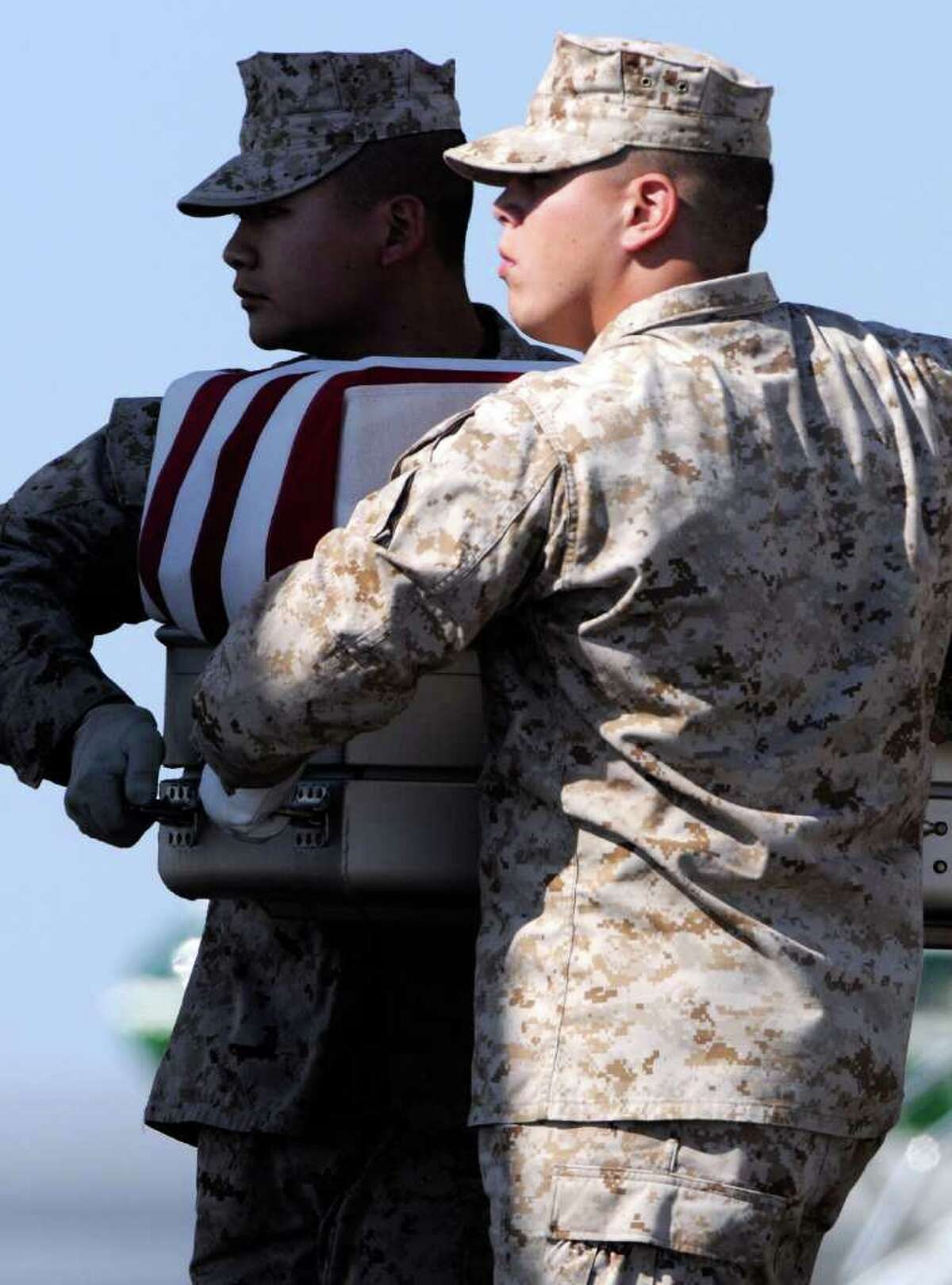 A Marine carry team moves a transfer case containing the remains of Lance Cpl. Benjamin W. Schmidt Saturday, Oct. 8, 2011 at Dover Air Force Base, Del. According to the Department of Defense, Schmidt, 24, of San Antonio, died Oct. 6, 2011 while conducting combat operations in Helmand, province, Afghanistan.
