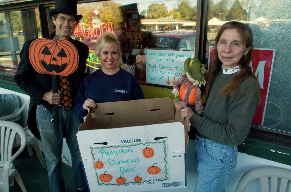 Billy Michael, Kathy Austin, and Billy's wife, Rosaly Donofrio, right, pose in front of Sycamore Diner in Bethel on Tuesday, Oct. 25, 2011. Because of the local pumpkin crop failure due to Tropical Storm Irene, Michael and Donofrio teamed up with the diner to gather donations of carved or uncarved pumpkins for the pumpkin festival they hold at their home on Fleetwood Avenue in Bethel.