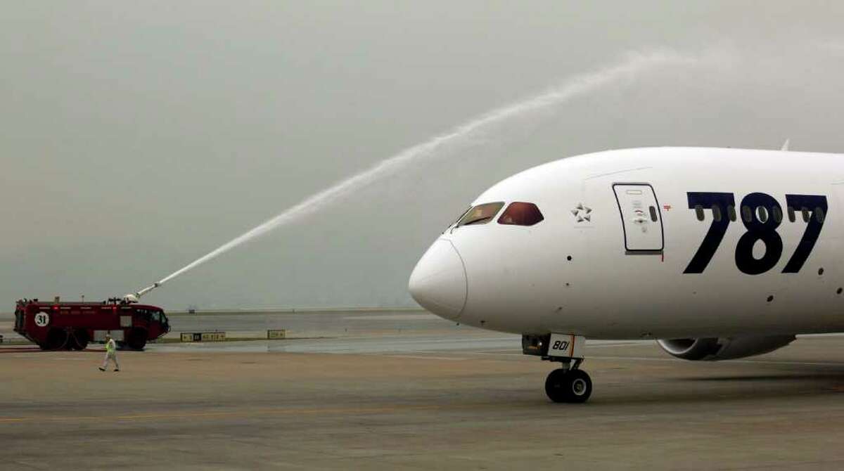 An All Nippon Airways Boeing 787 is sprayed water to celebrate its inaugural commercial flight from Japan, at Hong Kong International Airport on Wednesday. The jet, nicknamed The Dreamliner by Boeing, was flown by Japan's All Nippon Airways and was packed with aviation reporters and enthusiasts — some of whom paid thousands of dollars for the privilege.