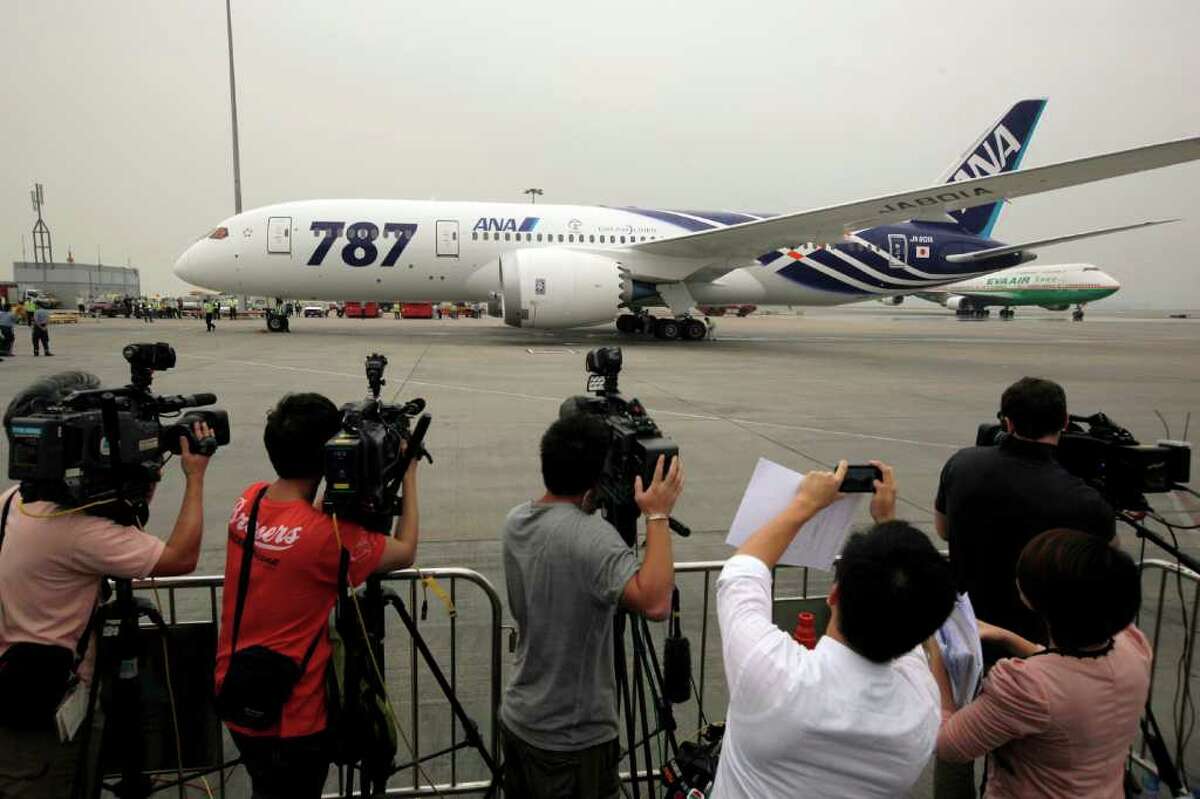 An All Nippon Airways Boeing 787 lands after its inaugural commercial flight from Japan, at Hong Kong International Airport on Wednesday. The jet, nicknamed The Dreamliner by Boeing, was flown by Japan's All Nippon Airways and was packed with aviation reporters and enthusiasts — some of whom paid thousands of dollars for the privilege.
