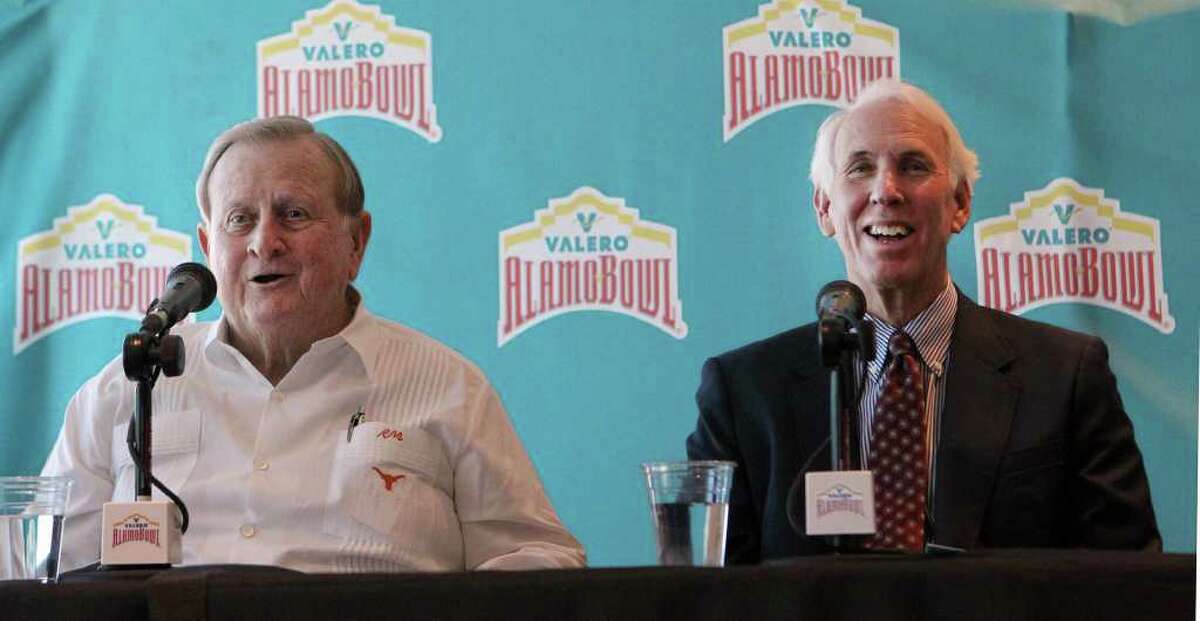 Red McCombs (left) and former Texas A&M coach R.C. Slocum (right) share a laugh during a news conference Wednesday October 26, 2011 at the Alamodome. McCombs, Slocum and others were there to introduce a new brand and marketing campaign concept for the Alamobowl with the message: "You Never Forget the Feeling." The marketing campaign comes from 18 years of Alamobowl college football tradition and will include promotions by use of television, print, radio, outdoor digital boards and the internet. JOHN DAVENPORT/jdavenport@express-news.net
