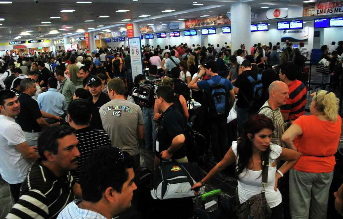 People stand in line to check-in at the international airport ahead of the arrival of Hurricane Rina in Cancun, Mexico, Wednesday Oct. 26, 2011. Authorities evacuated fishing communities and closed schools on Mexico's resort-studded Caribbean coast while some tourists began to leave as Hurricane Rina took aim at Cancun and the island of Cozumel on Wednesday. (AP Photo/Israel Leal)