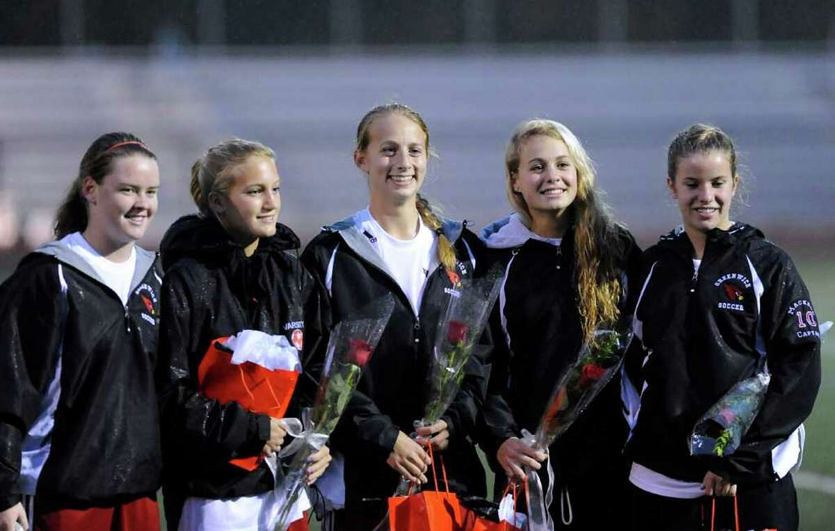 From left, Shannon Colligan, Hayden Stein, Amanda Onofrio, Tori Dunster and Izzy Mackell, all Greenwich High School soccer players and seniors who were honored at the start of girls high school soccer match between Greenwich High School and New Canaan High School at Greenwich, Thursday night, Oct. 27, 2011.