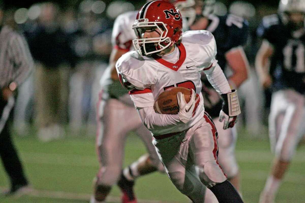 New Canaan wingback Duke Repko cuts back against the grain during his weaving second half touchdown run in second quarter action against Wilton. Repko's score put the Rams of New Canaan up 13-0.