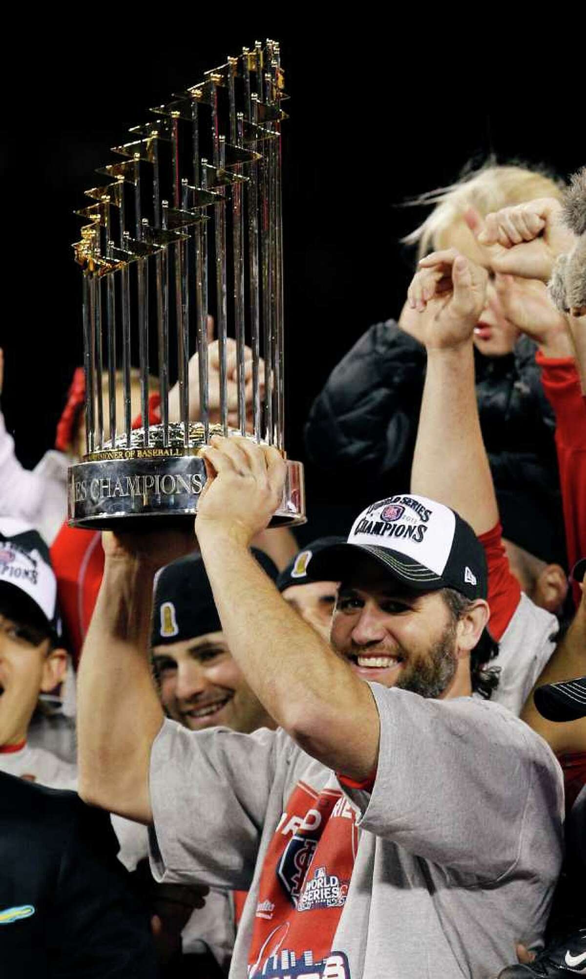 St. Louis Cardinals' Lance Berkman holds up the Commissioner's Trophy after Game 7 of baseball's World Series against the Texas Rangers Friday, Oct. 28, 2011, in St. Louis. The Cardinals won 6-2 to win the series. (AP Photo/Eric Gay)