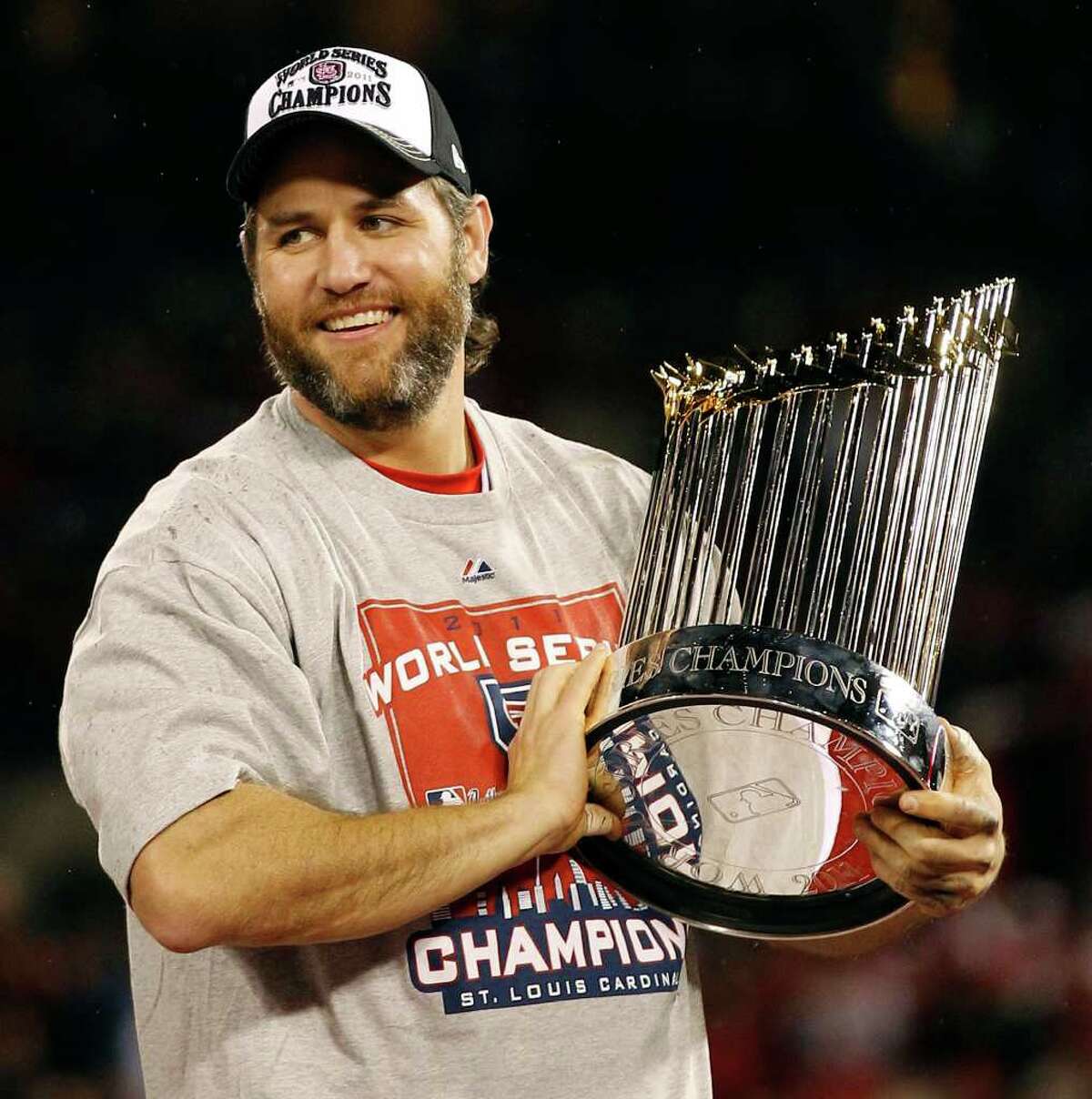 St. Louis Cardinals' Lance Berkman holds up the Commissioner's Trophy after Game 7 of baseball's World Series against the Texas Rangers Friday, Oct. 28, 2011, in St. Louis. The Cardinals won 6-2 to win the series. (AP Photo/Eric Gay)