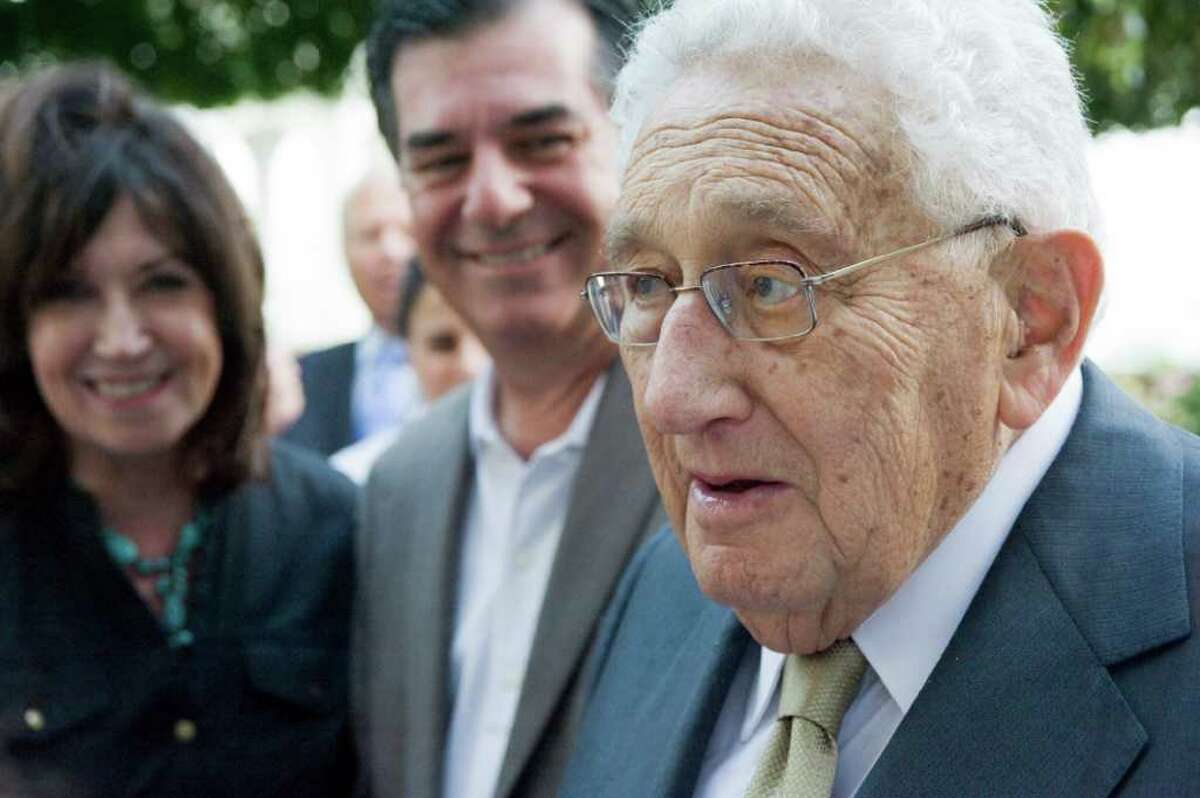 Nobel Prize winner and former Secretary of State Henry Kissinger socializes with Stamford Mayor Michael Pavia and his wife Maureen at Robert Dilenschneider's home in Darien, Conn., July 28, 2011. Kissinger will appear Friday, Nov. 4, from noon to 2 p.m. at the Hyatt Regency Greenwich at a luncheon to support Family Centers Inc., a human services non-profit with more than 30 programs in Fairfield County.