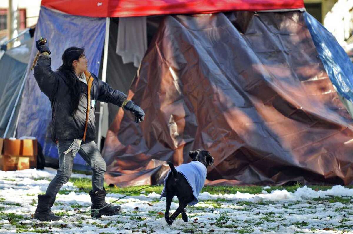 Oct. 29-30, 2011: Albany missed out on the worst of it, totaling fewer than four inches at Albany International Airport. Soojee Eckhardt-Rigberg of Albany plays with her dog Obi near her tent at the Occupy Albany encampment in Academy Park on Sunday Oct. 30, 2011.
