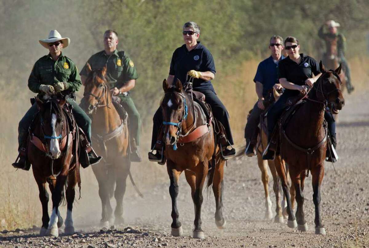 Homeland Security Secretary Janet Napolitano, center, tours the U.S.-Mexico border with Border Patrol agents in the Coronado National Forest near Nogales, Ariz. Sunday, Oct. 30, 2011. (AP Photo/The Arizona Republic, Michael Chow) MARICOPA COUNTY OUT; MAGS OUT; NO SALES