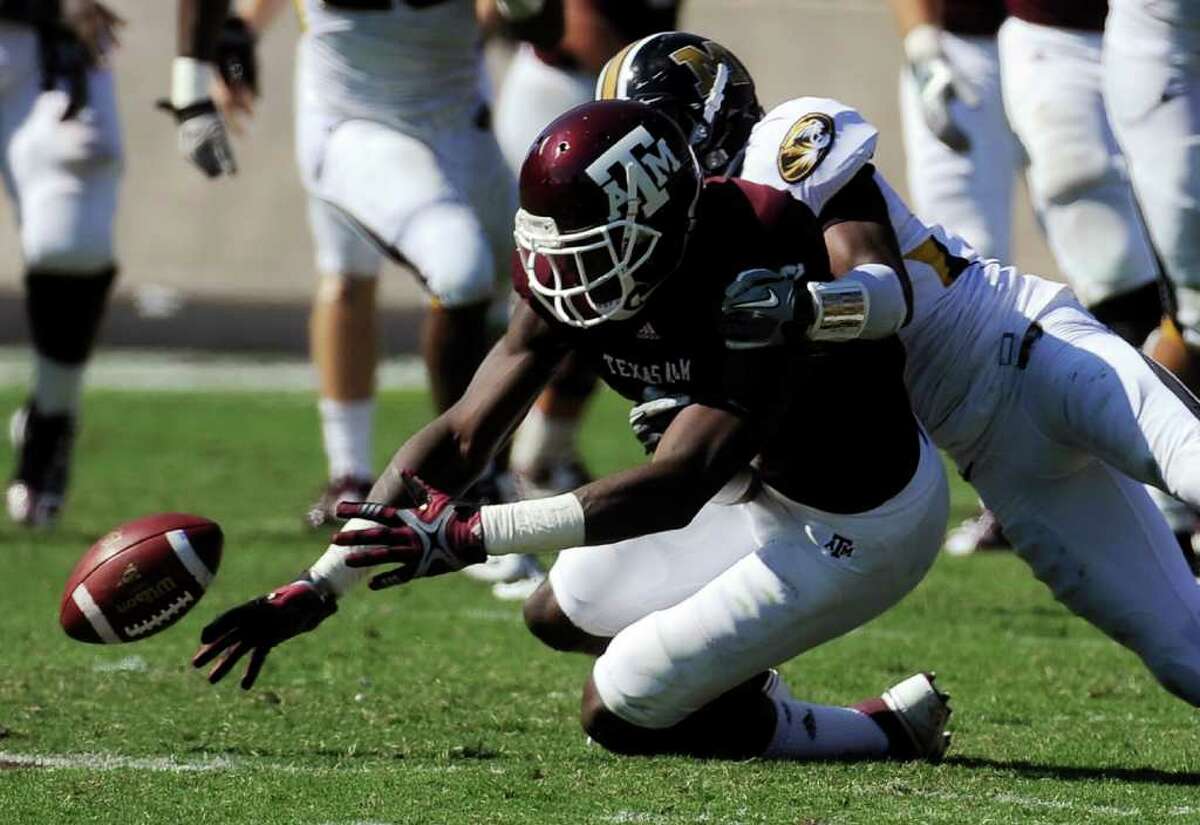 Texas A&M receiver Jeff Fuller can’t hold onto the ball as he’s hit by Missouri defensive back E.J. Gaines on Saturday.