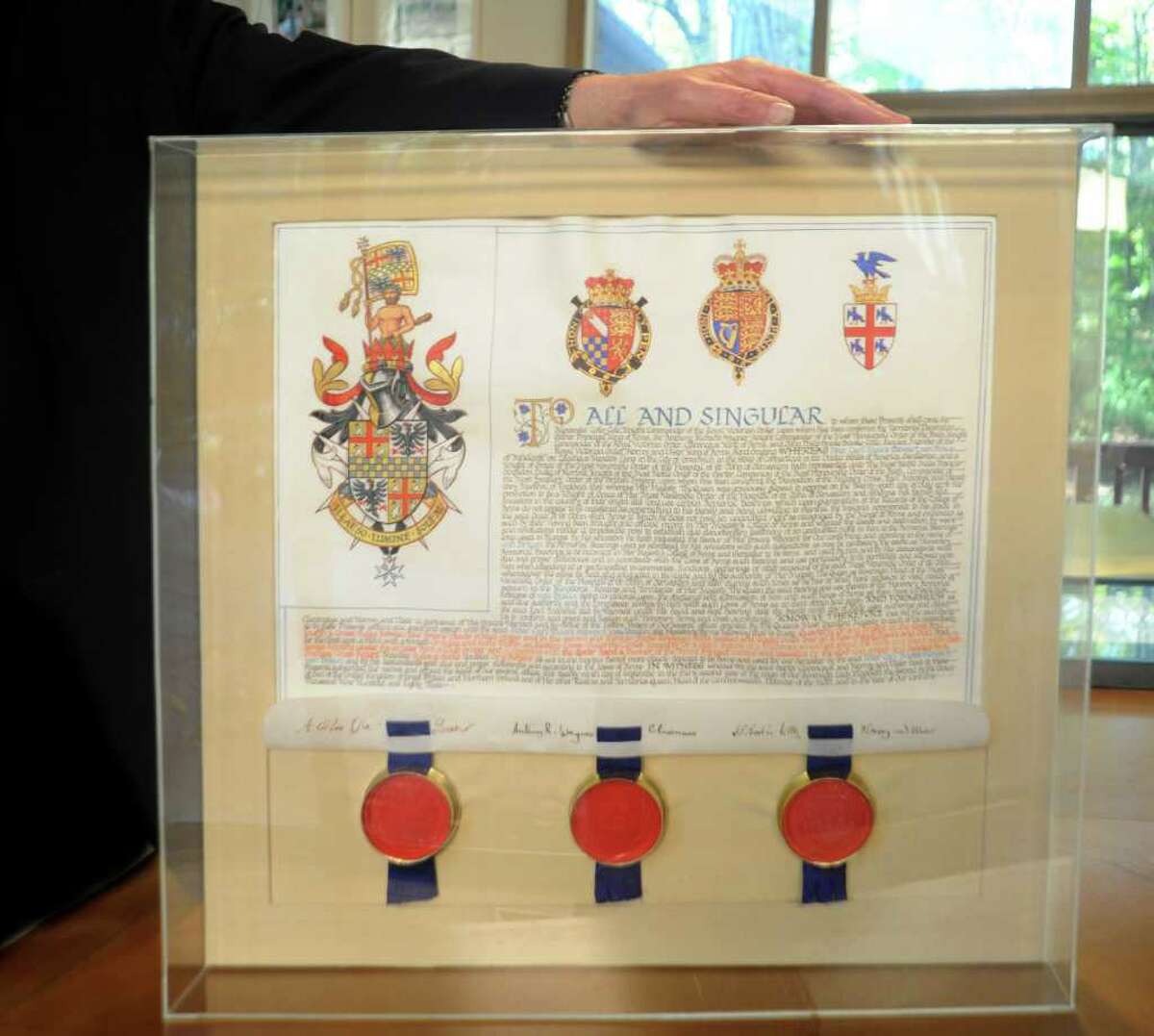 Peter von Braun, a Republican candidate for Board of Education displays material Tuesday, Nov. 1, 2011, shows he received an honorary knighthood from Queen Elizabeth II.