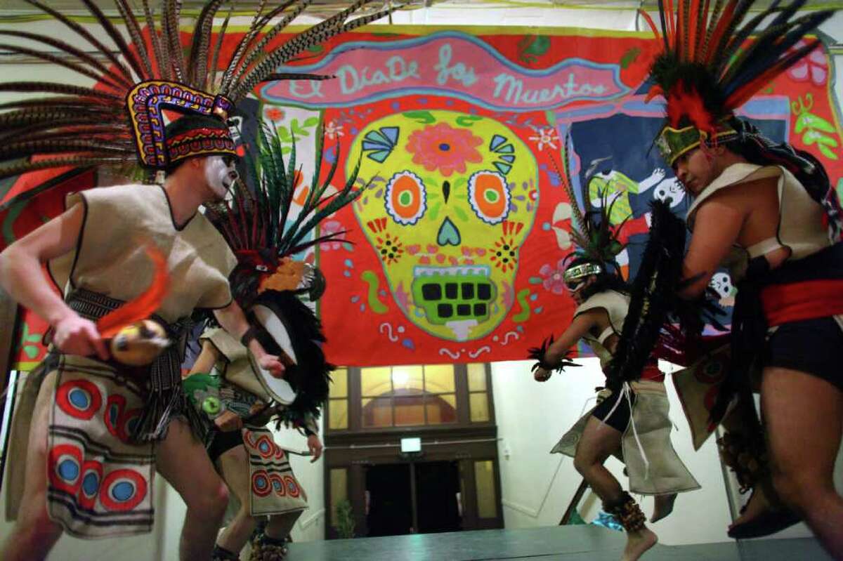 Members of "Ameyaltonal" Aztec dance group perform during a Día de los Muertos celebration at El Centro de la Raza.