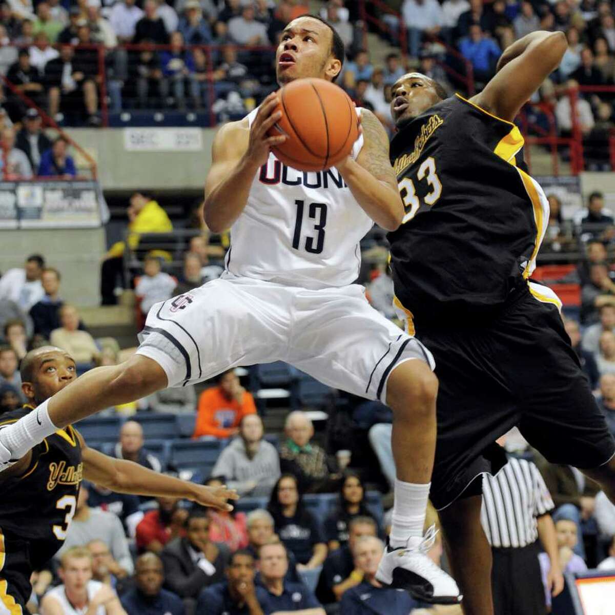 Connecticut's Shabazz Napier rises up past American International's Braxton Gardner for a shot in the second half of an NCAA college basketball exhibition game Wednesday, Nov. 2, 2011, in Storrs, Conn. Connecticut defeated American International 78-35. (AP Photo/Bob Child)