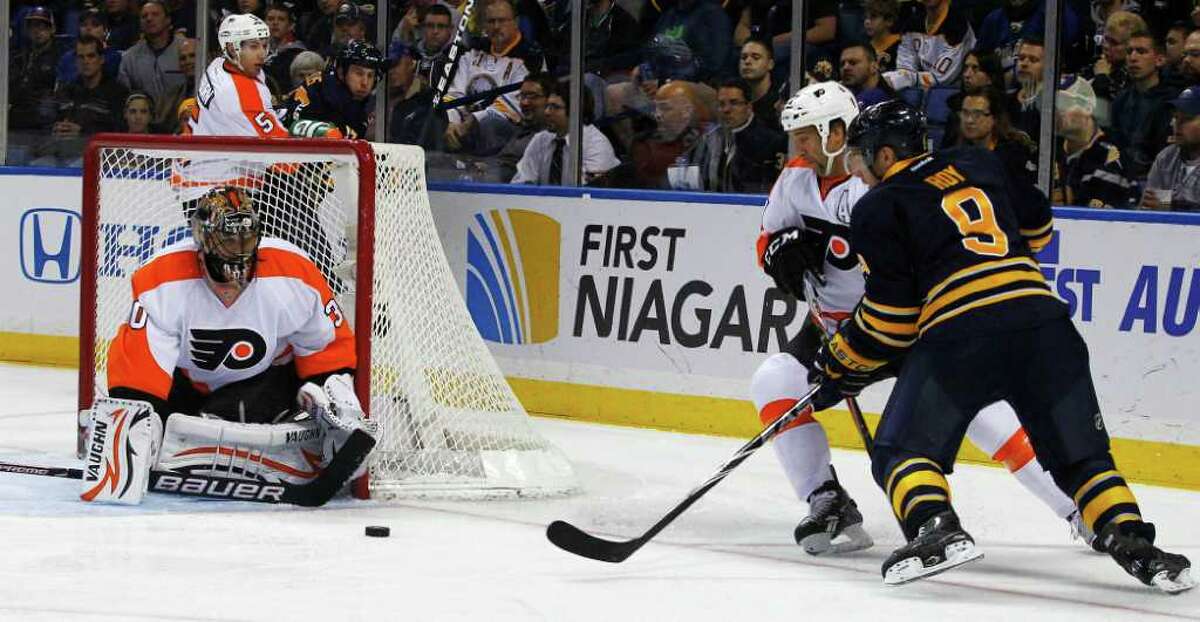 JOHN HICKEY : ASSOCIATED PRESS GOT IT COVERED: The Sabres' Derek Roy, right, takes a shot on goal as Flyers goaltender Ilya Bryzgolav, left, defends and defenseman Maxime Talbot covers during the first period of the Flyers' 3-2 win.