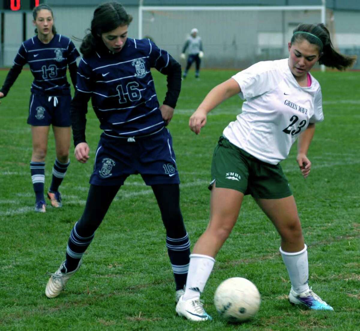 SPECTRUM/Breanne Rehaag of New Milford High School girls' soccer employs some deft footwork to move the ball past an Immauclate defender during the Green Wave's 1-0 victory Oct. 29, 2011 over the Mustangs during a South-West Conference quarterfinal playoff match at NMHS.