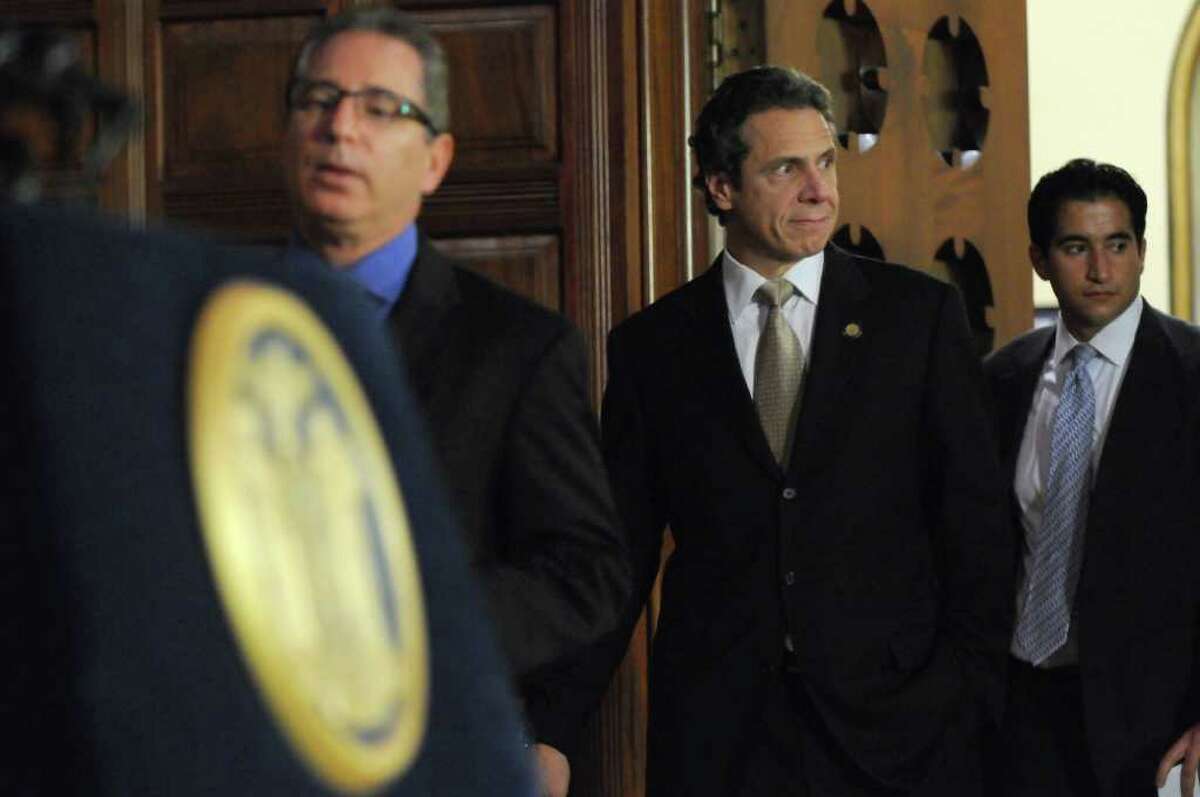 Gov. Andrew Cuomo walks into the Red Room from his office to discuss PEF workers voting in favor of the state's contract proposal, thereby avoiding layoffs, in the Capitol on Thursday Nov. 3, 2011 in Albany, NY. Director of Operations Howard Glaser is at left, and spokesman Josh Vlasto is at right. (Philip Kamrass / Times Union )