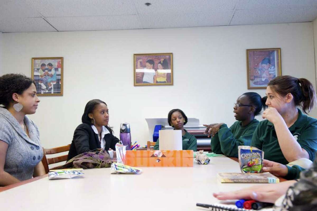 Stamford Academy family advocate Christina Howell, left, and students from left, Leatrice Bond, 16, Asia Currie, 15, Shaquala Brown, 17, and Jasmine Vanaskey, 16, gather as a group of female Stamford Academy students meets for gender specific programming, as part of a new DOMUS initiative in Stamford, Conn., November 3, 2011. A nonprofit, Domus operates programs for local youths. Recently the program was awarded a $7,800 grant from the Fairfield County Community Foundation to fund programs helping girls address their social and emotional needs in a safe environment.