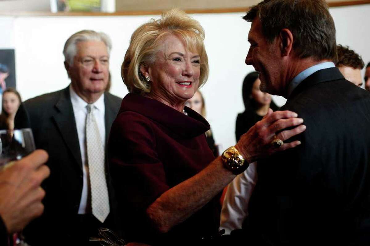 Honoree Patsy Fourticq visits with Neal Hamil during the reception; her husband, Greg Fourticq, is in the background.