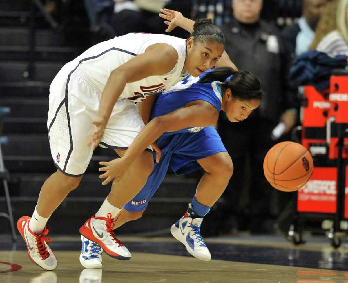 UConn's Kaleena Mosqueda-Lewis, left, and Assumption's Gabrielle Gibson chase down a loose ball in the first half of an exhibition game Thursday in Storrs.