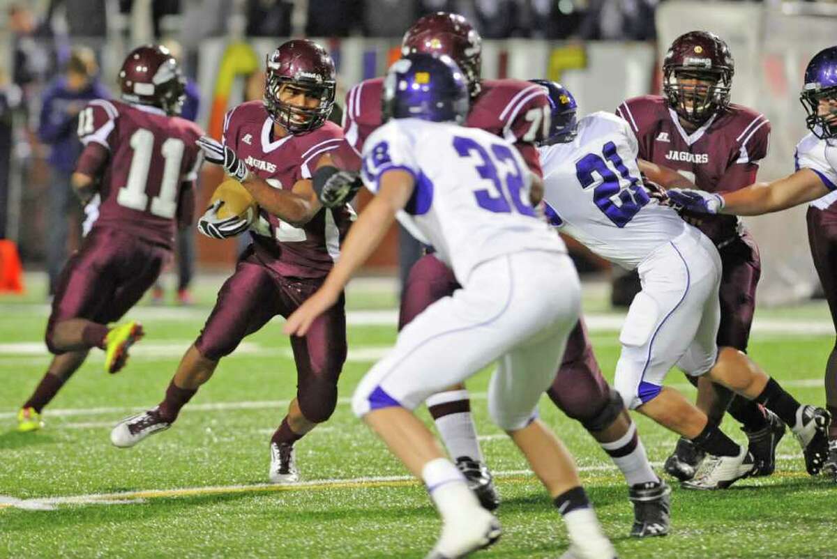 Central's #21, RB Emanuel Carter, left, looks for a hole between Port Neches-Groves defenders, #32Dalton Peveto, and #21, Justin Speri. in first half action at the Carrol A. "Butch" Thomas Educational Support Center. At the half, the score was Indians 21, Central 0. Dave Ryan/The Enterprise