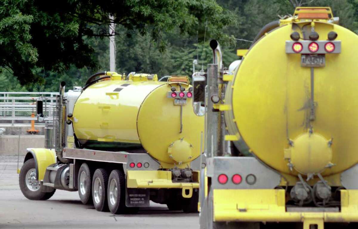 A pair of tanker trucks carrying waste water from natural gas hydrofracking arrive this summer at the municipal sewer treatment plant in in McKeesport, Pa. Environmental groups Clean Water Action and Three Rivers Waterkeeper have sued in federal court to stop Keesport from accepting such water for disposal in the Monongahela River. (Keith Srakocic / AP)