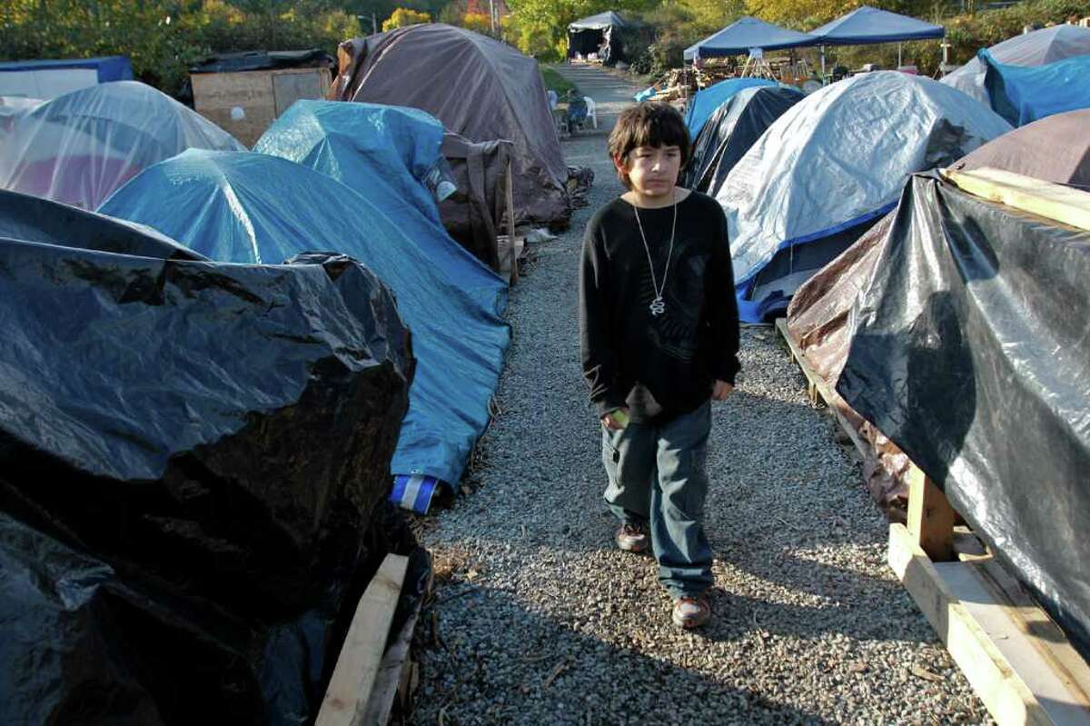 K'eet Dundas, 11, walks among the tents in the 'Nickelsville' tent community in West Seattle on Saturday, Nov. 5, 2011. Over 130 people are housed here on any given day and as the weather gets colder many are struggling to stay warm. K'eet's mother Martina said its really cold and there needs to be more funding for families. She said there is almost always a place for a couple, but there is not very much support for families that want to stay together. Currently there are at least four pregnant women living Nickelsville.