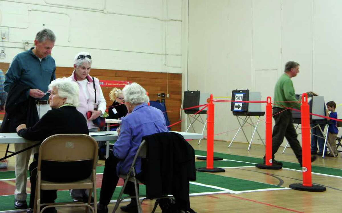 Voters check in at the polling station at Long Lots Elementary School on Tuesday, Nov. 8, 2011.