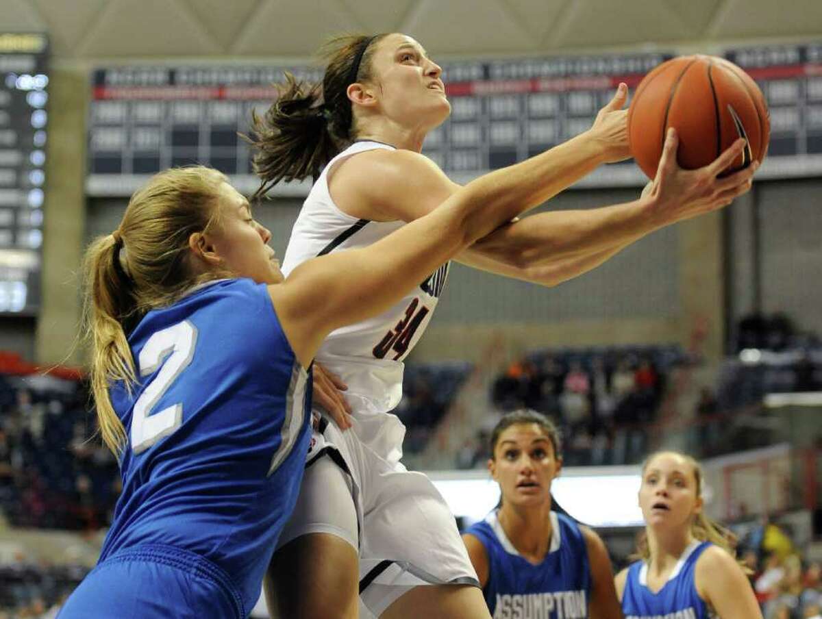 Connecticut's Kelly Faris, right, is fouled by Assumption's Jamie Insel in the first half of an NCAA women's college basketball exhibition game Storrs, Conn., Thursday, Nov. 3, 2011. (AP Photo/Jessica Hill)